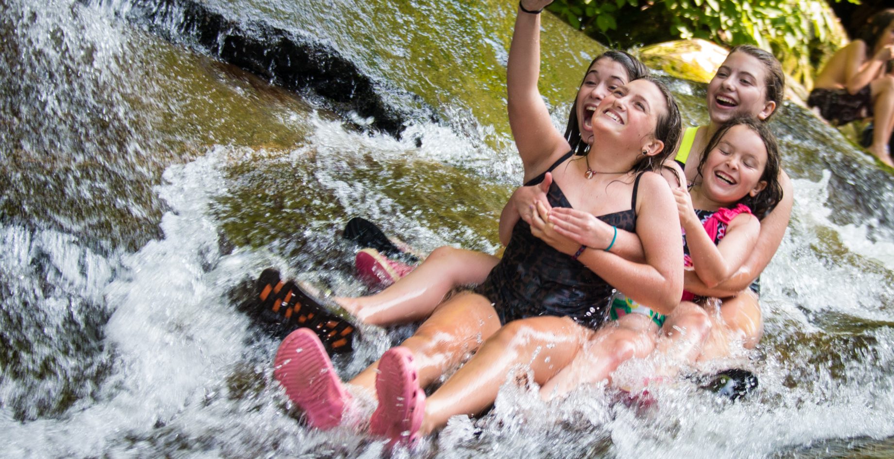 Campers swimming and taking photo.